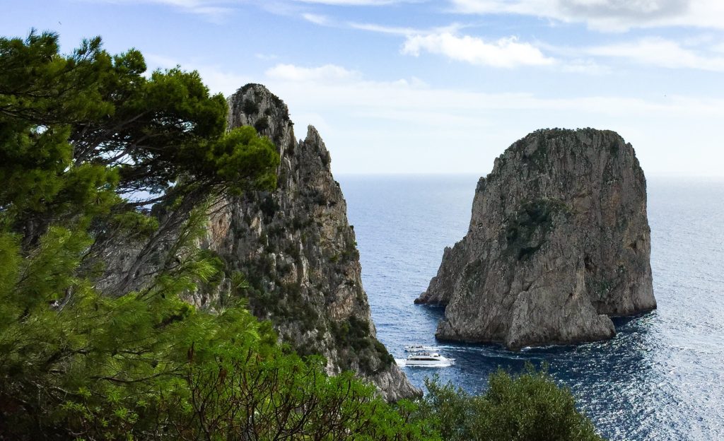View of the Faraglioni from the trail to the Punta Tragara viewpoint in Capri, Italy