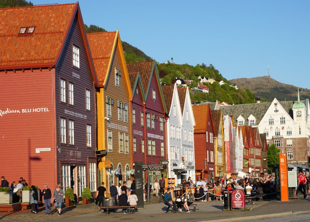 Bryggen bustles with activity on a sunny afternoon in Bergen, Norway