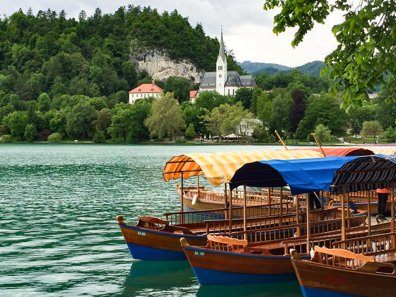 Pletna Boats docked right below Hotel Park in Lake Bled Slovenia