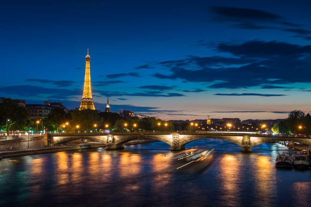 Paris, France, with Eiffel Tower lit up at night