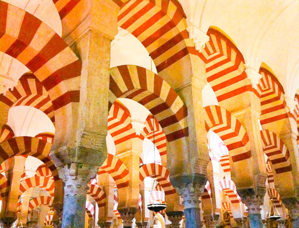 The candy cane arches of the Mezquita in Cordoba, Spain: Cordoba is one of the best day trips from Seville you can do.