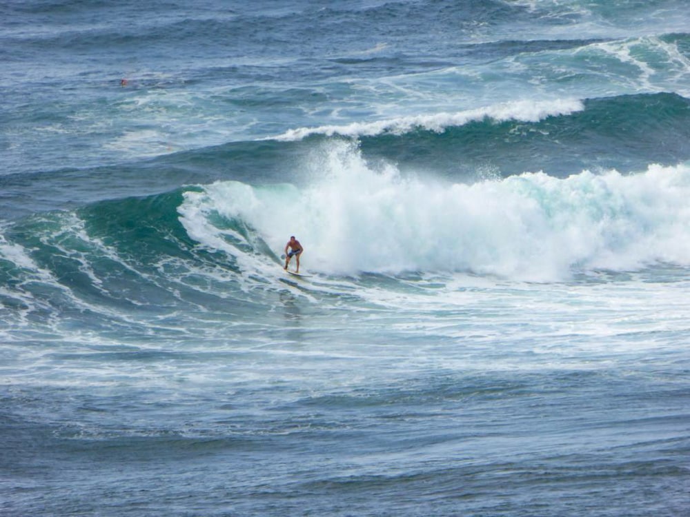 Surfer riding the waves in Maui, Hawaii