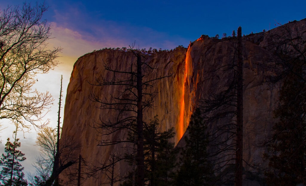 Horsetail Fall glows orange at sunset in mid-February in Yosemite National Park in California