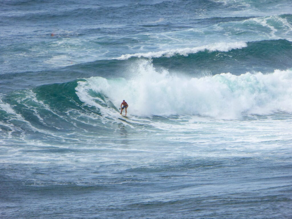 A surfer at Honolua Bay in Maui, HI